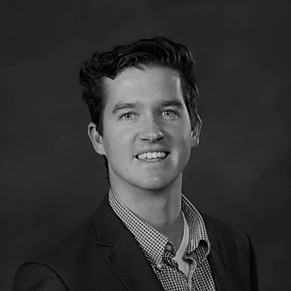 A black and white photo of a man in a suit.